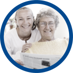 an elderly and a caregiver showing smiling faces