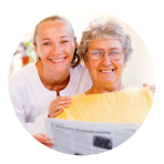 an elderly and a caregiver showing smiling faces